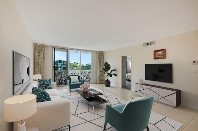 tiled living room featuring a wall of windows