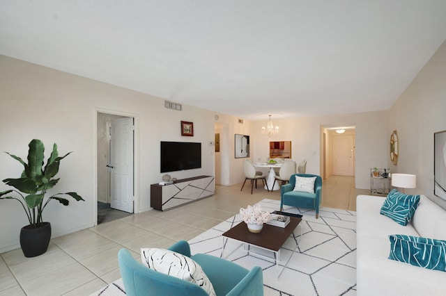 living room featuring tile patterned flooring and an inviting chandelier