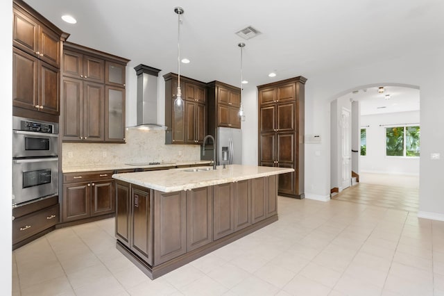 921 Osceola Dr Unit 11, Boca Raton, FL 33432 - kitchen with wall chimney range hood, a sink, appliances with stainless steel finishes, visible vents, and arched walkways
