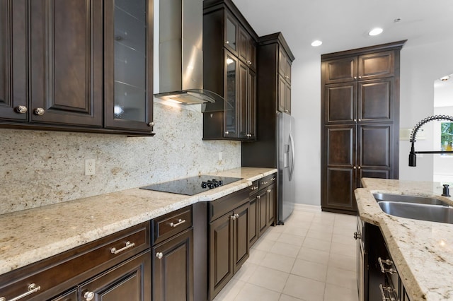 921 Osceola Dr Unit 11, Boca Raton, FL 33432 - kitchen featuring dark brown cabinetry, black electric cooktop, wall chimney exhaust hood, and a sink