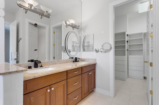 921 Osceola Dr Unit 11, Boca Raton, FL 33432 - bathroom featuring tile patterned flooring, a sink, double vanity, and baseboards