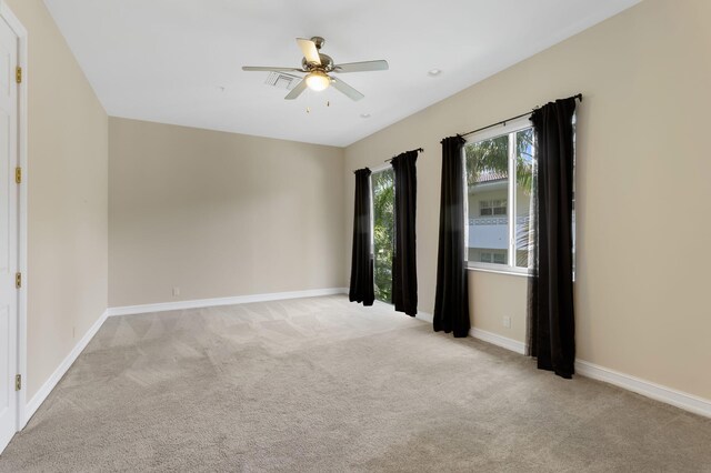 921 Osceola Dr Unit 11, Boca Raton, FL 33432 - unfurnished room featuring baseboards, a ceiling fan, and light carpet