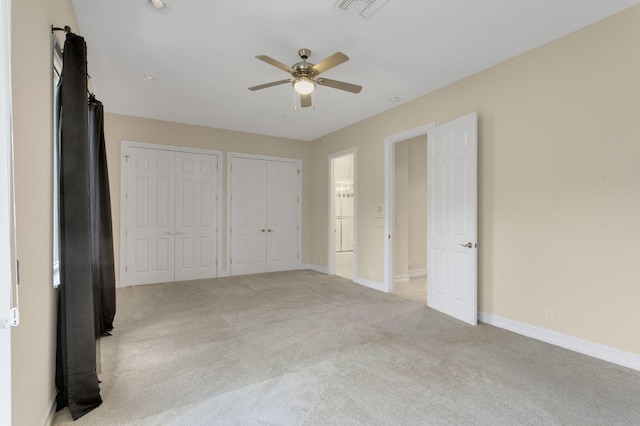 921 Osceola Dr Unit 11, Boca Raton, FL 33432 - unfurnished bedroom with multiple closets, a ceiling fan, visible vents, baseboards, and light colored carpet