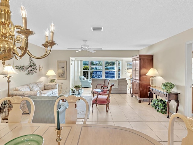 living room featuring ceiling fan, a textured ceiling, and light tile patterned flooring