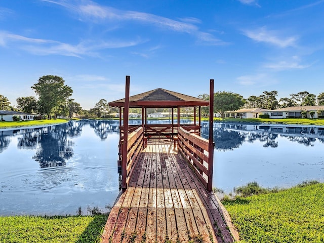 view of dock with a gazebo and a water view