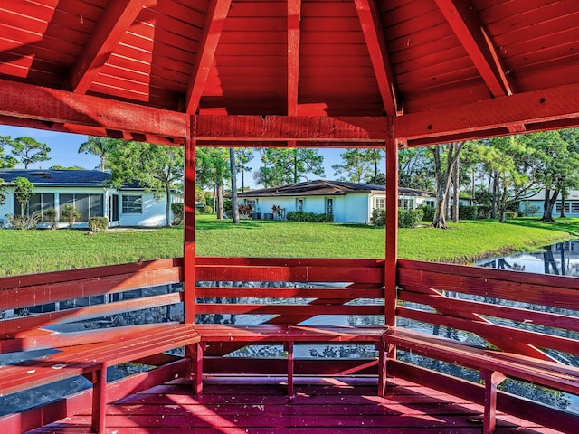 view of patio with a gazebo and a water view