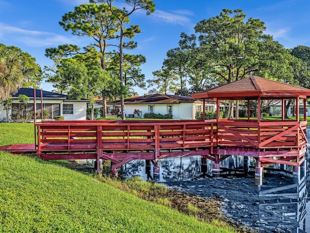 view of dock featuring a gazebo and a yard