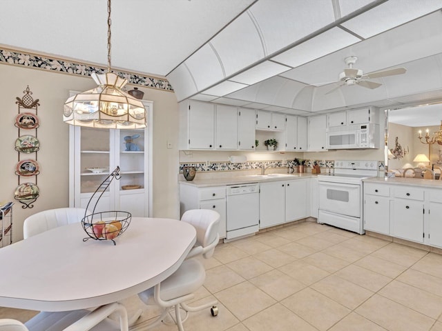 kitchen with hanging light fixtures, sink, backsplash, white cabinets, and white appliances