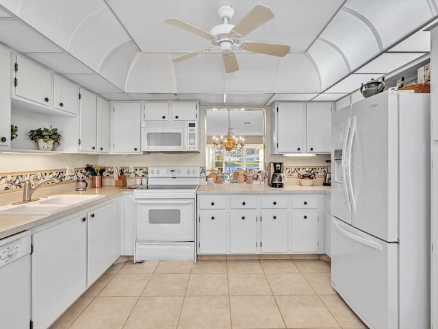 kitchen featuring sink, white appliances, and white cabinets