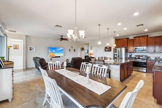 dining room featuring ceiling fan with notable chandelier