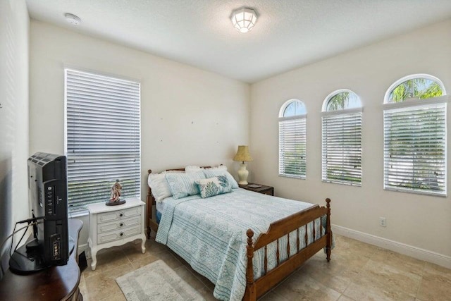 bedroom featuring multiple windows