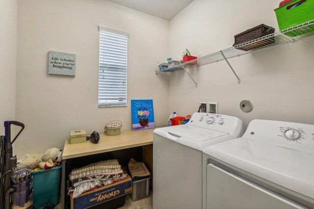 clothes washing area with washing machine and dryer