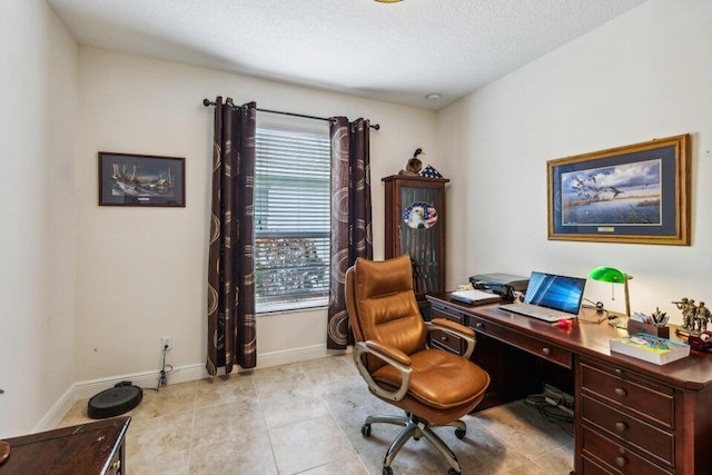 tiled office featuring a textured ceiling