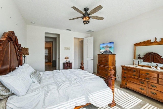 tiled bedroom featuring ceiling fan