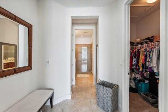 hall featuring light tile patterned floors