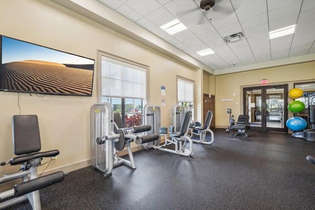 workout area featuring a drop ceiling and french doors