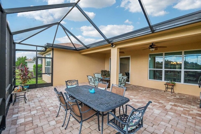 view of patio featuring ceiling fan and a lanai