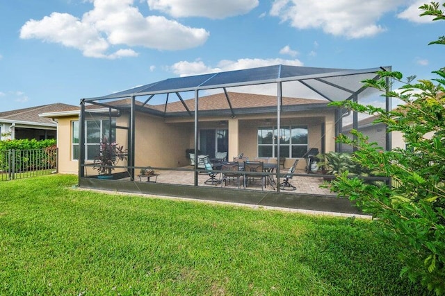 back of property with a lanai, a lawn, and a patio