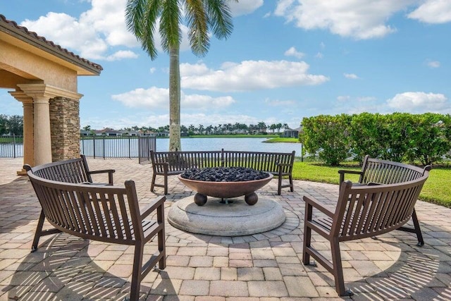 view of patio / terrace featuring a water view and an outdoor fire pit