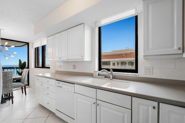 kitchen with sink, white cabinets, a textured ceiling, and white dishwasher