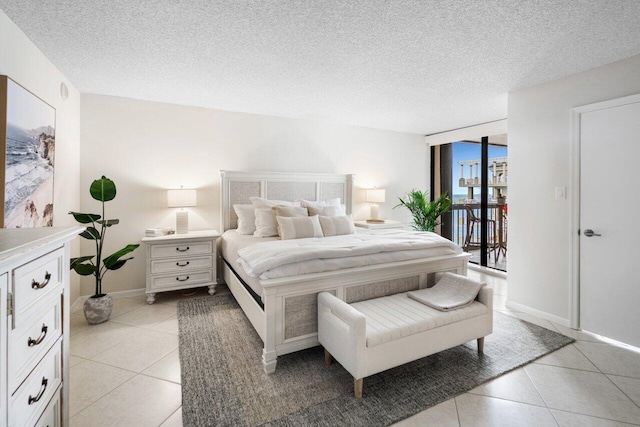 bedroom featuring light tile patterned floors, a textured ceiling, and floor to ceiling windows