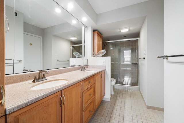 bathroom featuring an enclosed shower, vanity, toilet, and tile patterned flooring