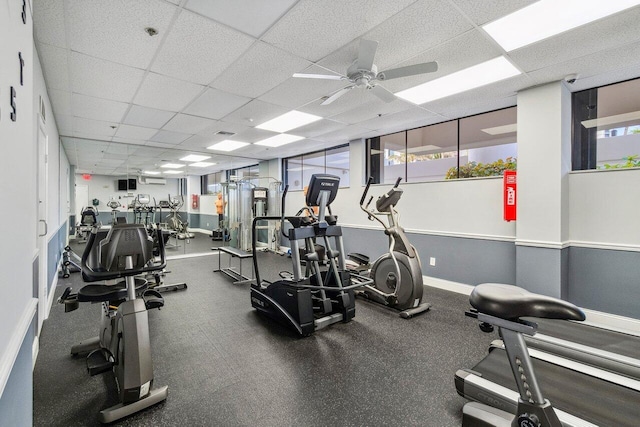 workout area with ceiling fan and a drop ceiling