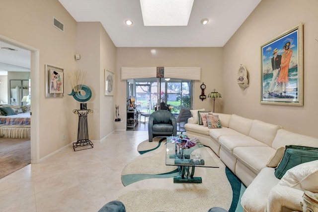 tiled living room featuring a skylight