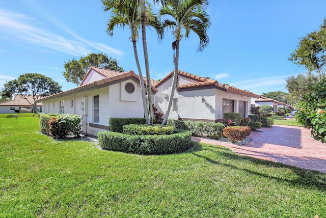 view of side of property with a lawn