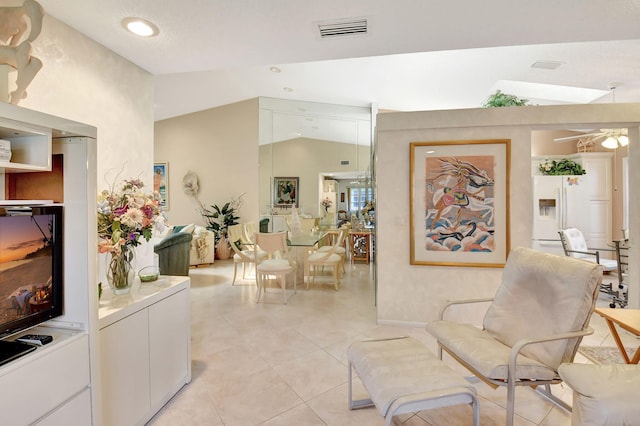 sitting room with vaulted ceiling and light tile patterned flooring