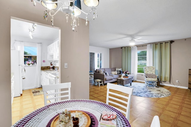 dining space with sink and ceiling fan