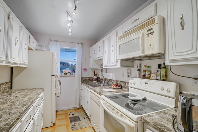 kitchen with sink, white appliances, and white cabinets