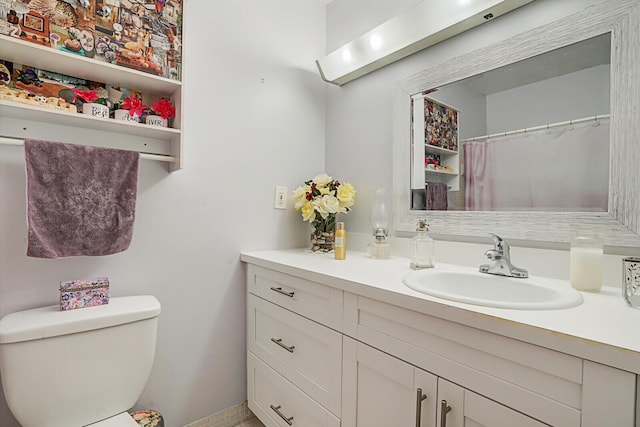 bathroom featuring toilet and vanity