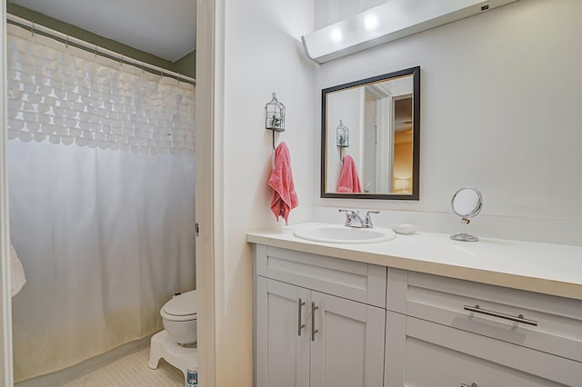 bathroom featuring vanity, toilet, and walk in shower