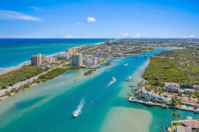 birds eye view of property featuring a water view and a beach view