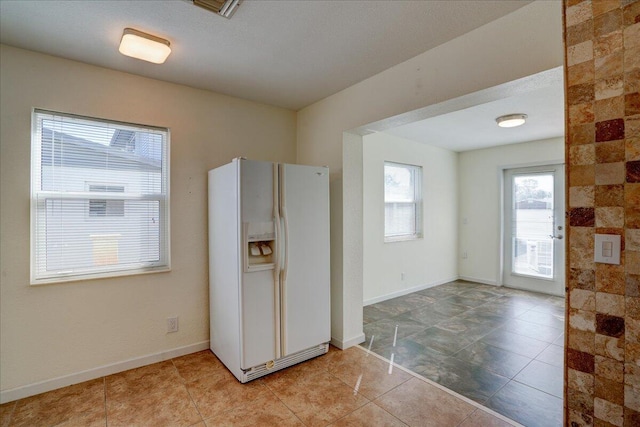 kitchen featuring white fridge with ice dispenser