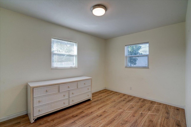 unfurnished room featuring plenty of natural light and light hardwood / wood-style flooring