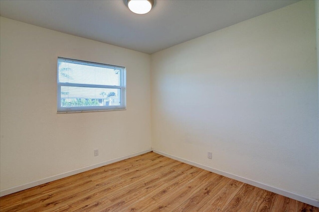 empty room with light hardwood / wood-style flooring