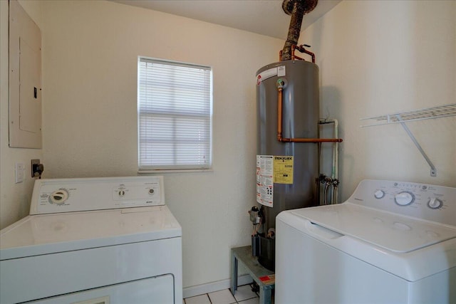 clothes washing area with separate washer and dryer, electric panel, light tile patterned floors, and gas water heater