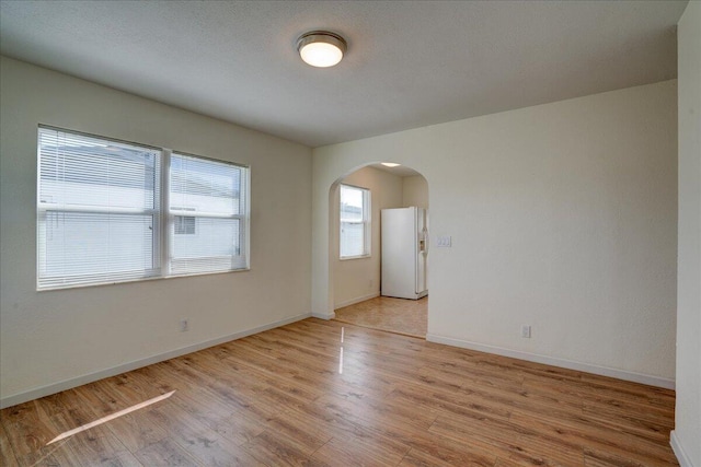 spare room featuring light wood-type flooring