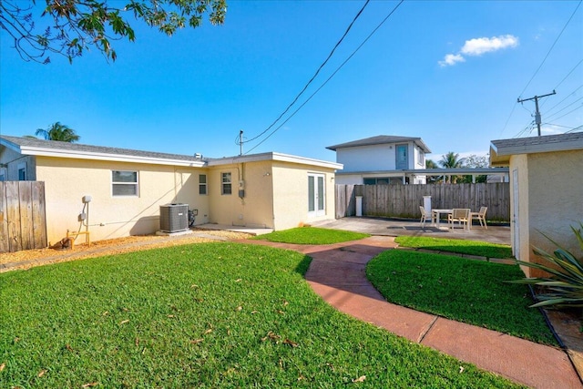 back of property featuring a patio area, central AC unit, and a lawn