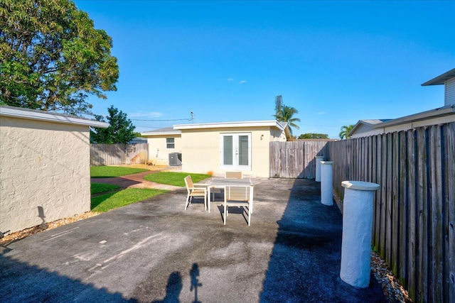 back of property featuring cooling unit, a patio area, and french doors