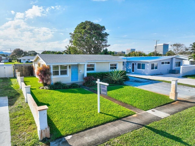 ranch-style home with a front lawn