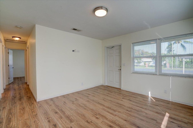 empty room with light hardwood / wood-style flooring