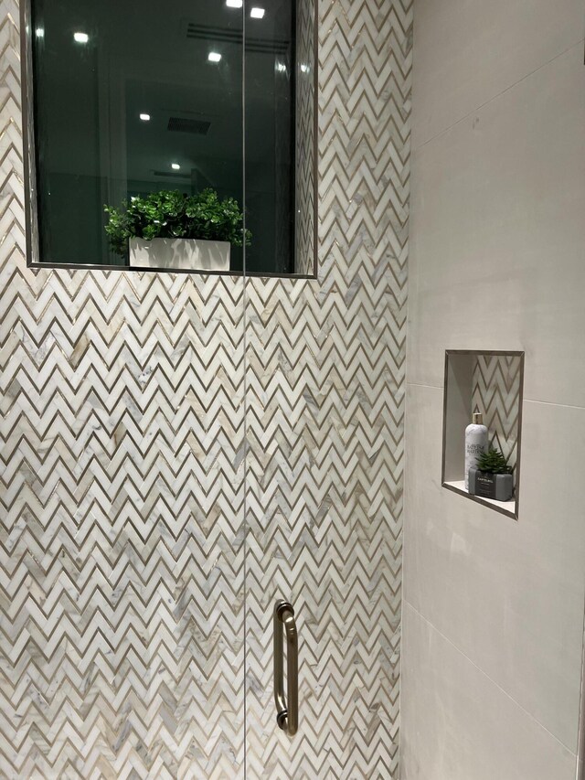 details featuring visible vents and a tile shower