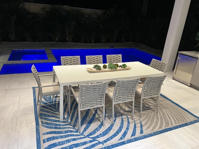 view of swimming pool featuring outdoor dining area and a patio