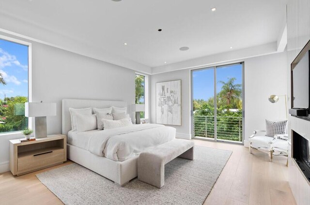 260 31st St, West Palm Beach, FL 33407 - bedroom with light wood-style flooring and access to outside