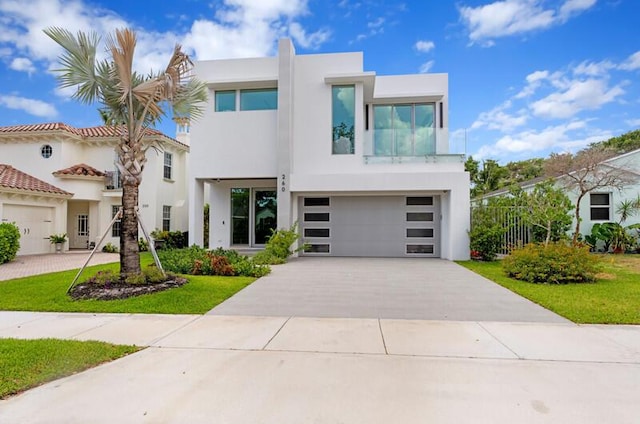 260 31st St, West Palm Beach, FL 33407 - view of front of property with stucco siding, driveway, and an attached garage