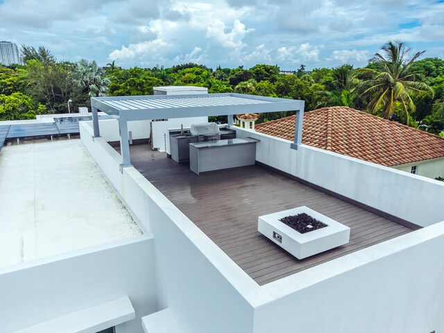 exterior space with an outdoor fire pit and exterior kitchen