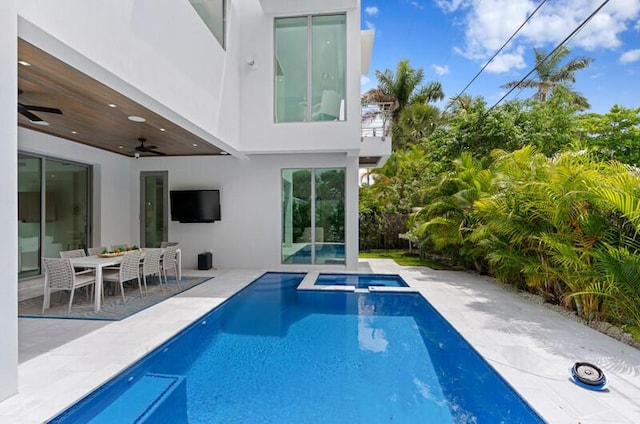 260 31st St, West Palm Beach, FL 33407 - view of pool with a pool with connected hot tub, a ceiling fan, a patio, and outdoor dining area